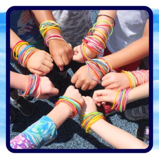 Students hands in circle with lap reward bracelets.